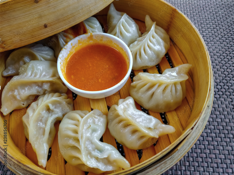 Plate of Signature Chicken Momos with Sauce